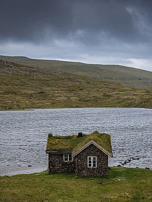 A lonely house in the island of Sandoy, Faeroe islands, Denmark, Europe